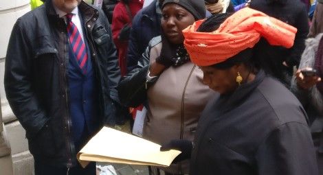 Rebecca Sharibu holding a petition outside the Nigerian High Commission