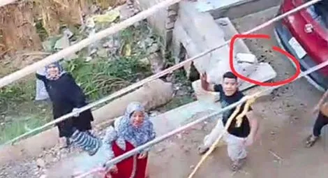 Attackers outside the church building in Tal Al-Quiblya.