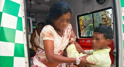 A victim from the attack on Christians in Sadrapal is helped out of an ambulance.