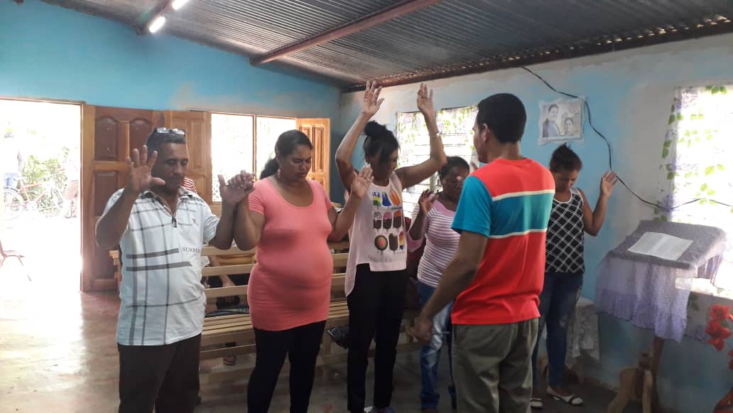 Pastor Rosabal and congregation