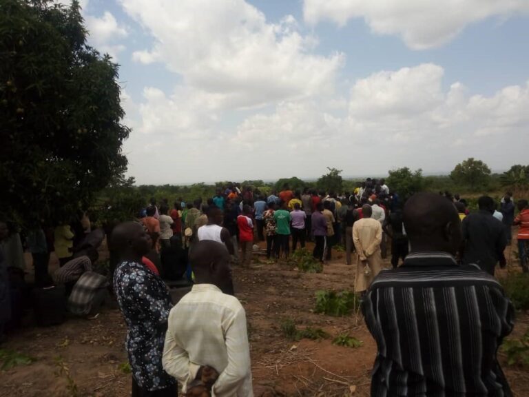Individuals gathered at mass burial