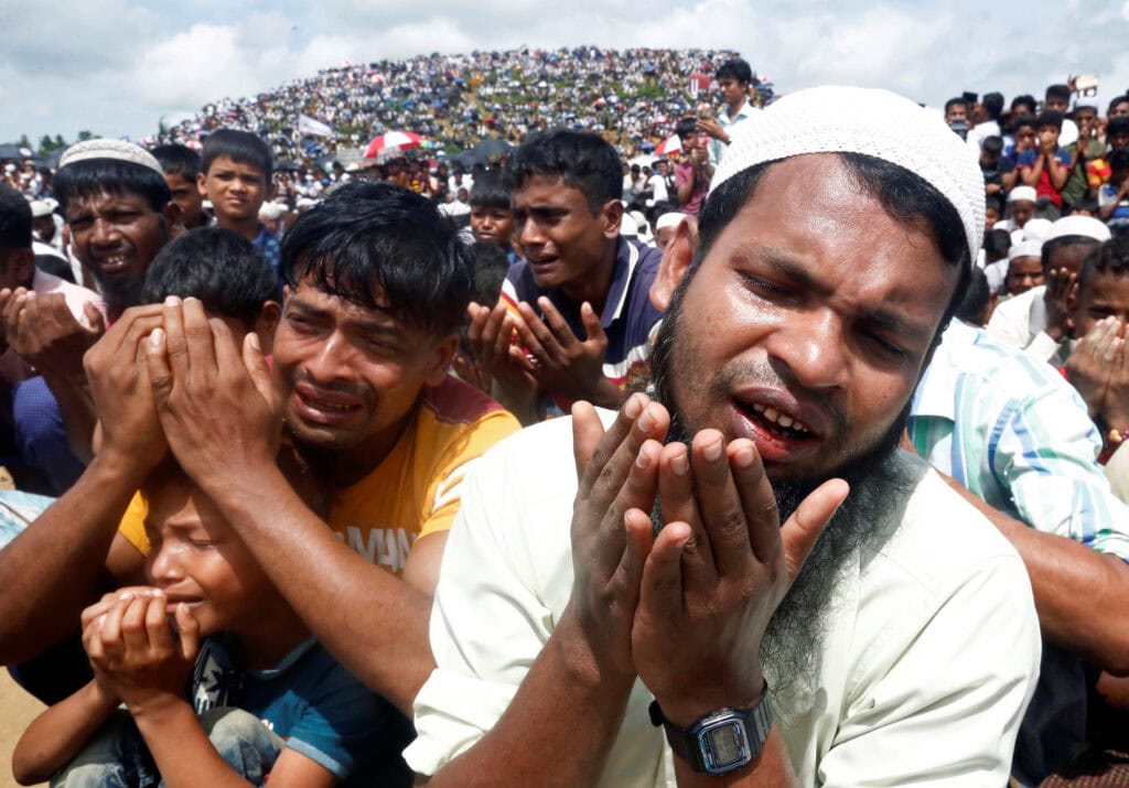 Rohingya refugees take part in a prayer as they gather to mark the second anniversary of the exodus at the Kutupalong camp in Coxs Bazar