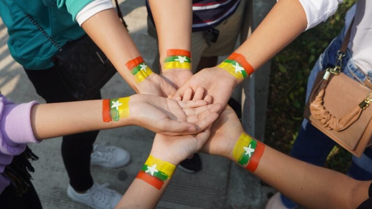 Protesters with Myanmar/Burma flag painted on their wrists.